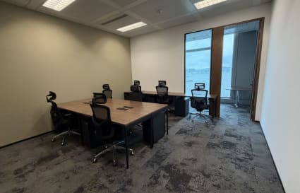 Stylish coworking space with ergonomic chairs and a vibrant city view in Tsim Sha Tsui.