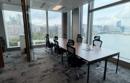 Sleek coworking space with stunning harbor views and ample natural light in Tsim Sha Tsui.
