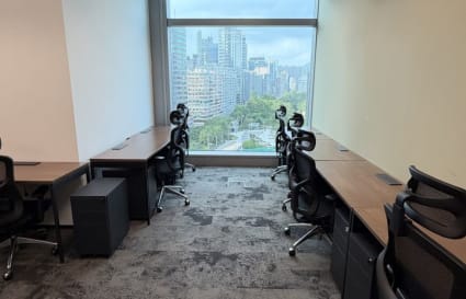 Modern coworking space with city views, ergonomic chairs, and ample natural light.