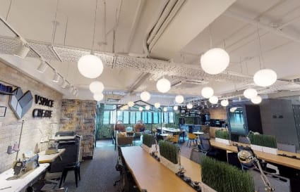 Bright coworking space with open desks, modern lighting, and natural accents in Kwai Chung.