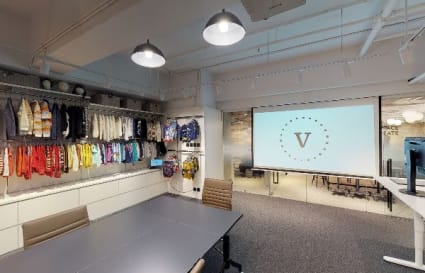 Modern coworking space in Kwai Chung featuring conference table, projector, and creative display.