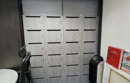 Compact workspace with secure storage and modern seating in a flexible coworking environment.