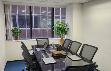 Modern coworking meeting room with ample natural light and sleek furnishings in Hok Yuen.