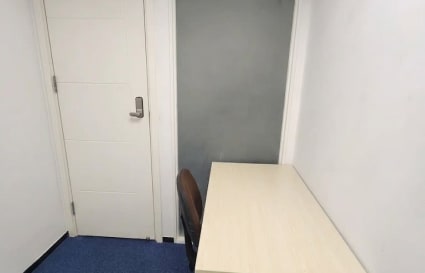 Compact office with desk and chair, ideal for focused solo work in Hok Yuen coworking space.