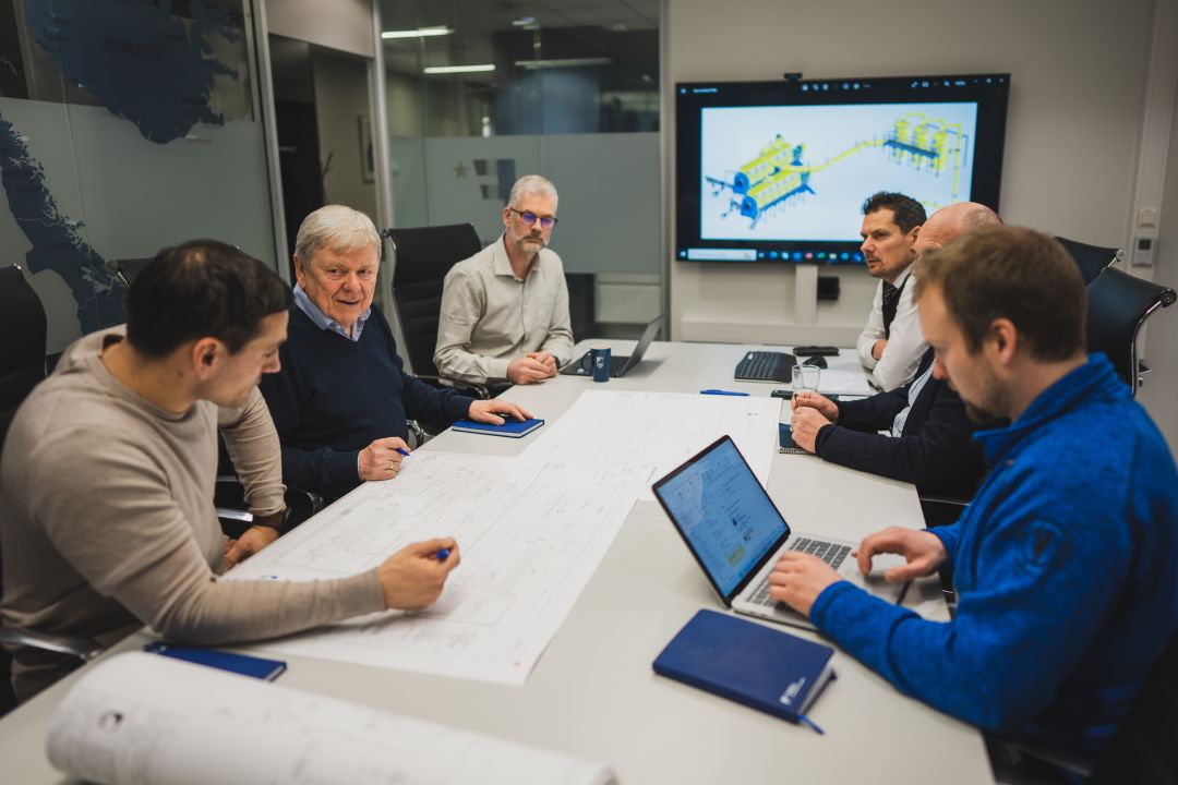 Fjell employees discussing new design and improvements on a project.