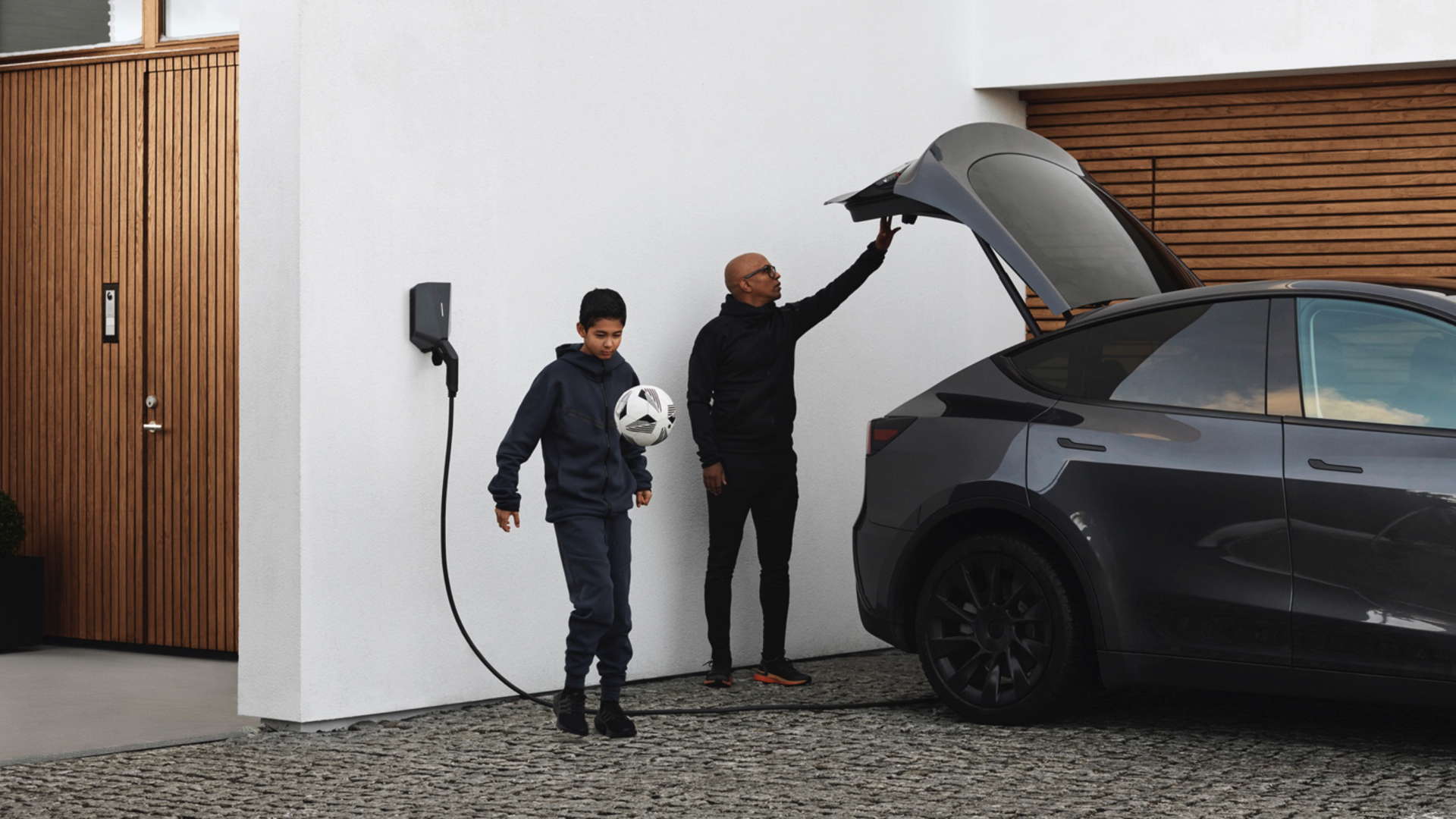 familie som lader en tesla med easee elbillader