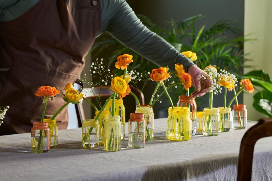 DIY påskebord med ranunkler og mimosa i fargede glass