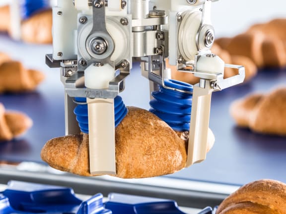 Pick and place robot grabs croissant