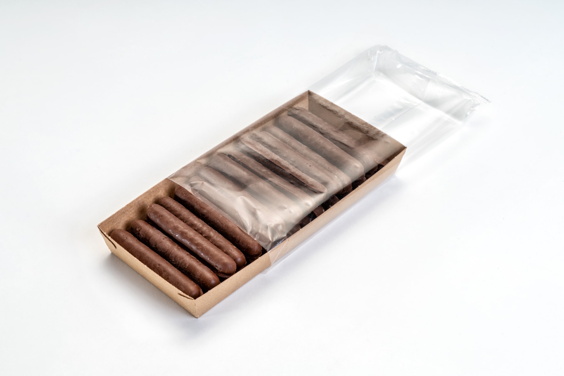 A cardboard tray filled with chocolate biscuits is enclosed in a transparent flowpack.