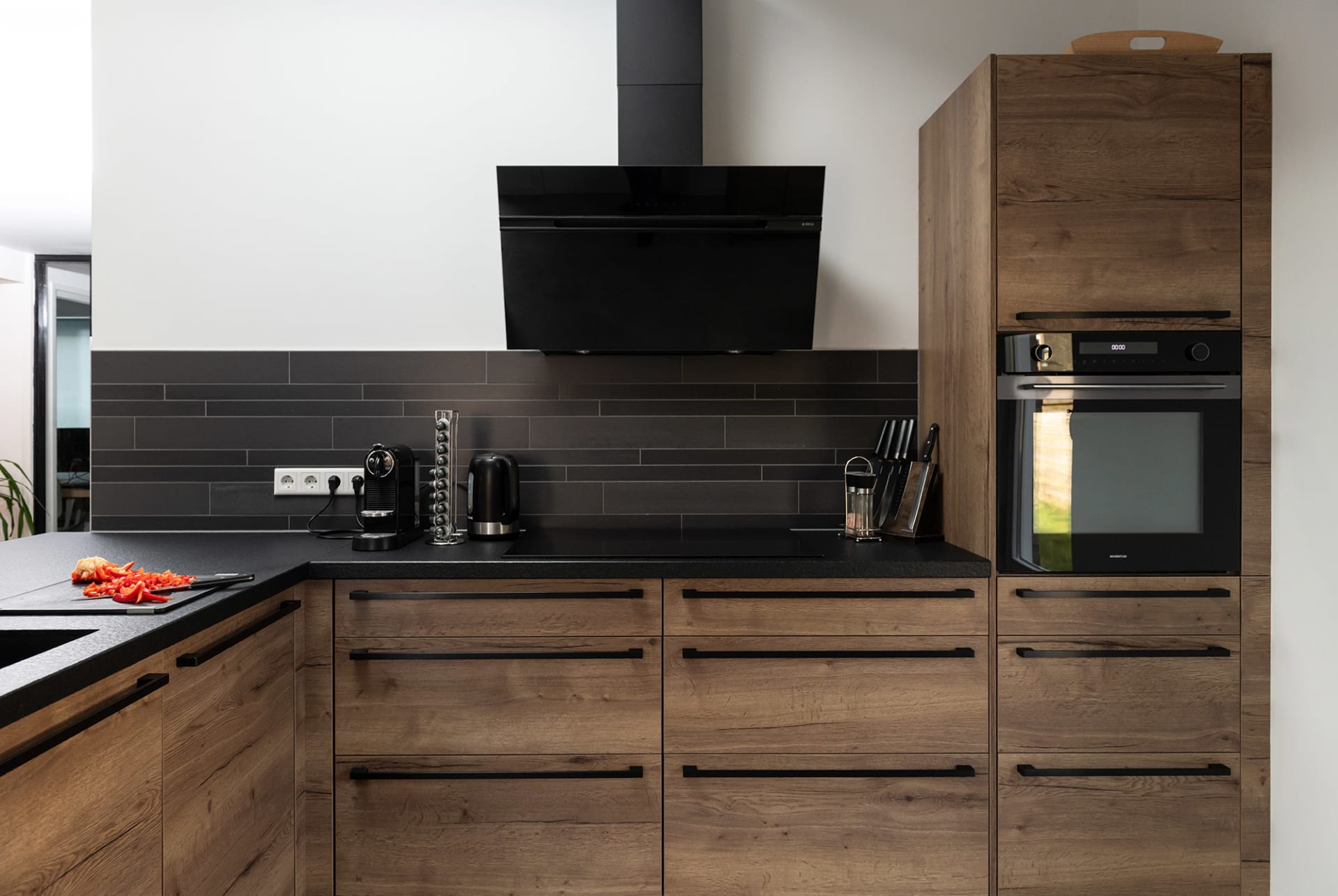 We wilden een keuken met karakter, eentje die niet bij iedereen in de straat staat. De combinatie van donker hout en staal maakt het stoer én warm tegelijk.