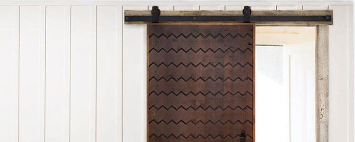 Barn door installation with a visible mounting header