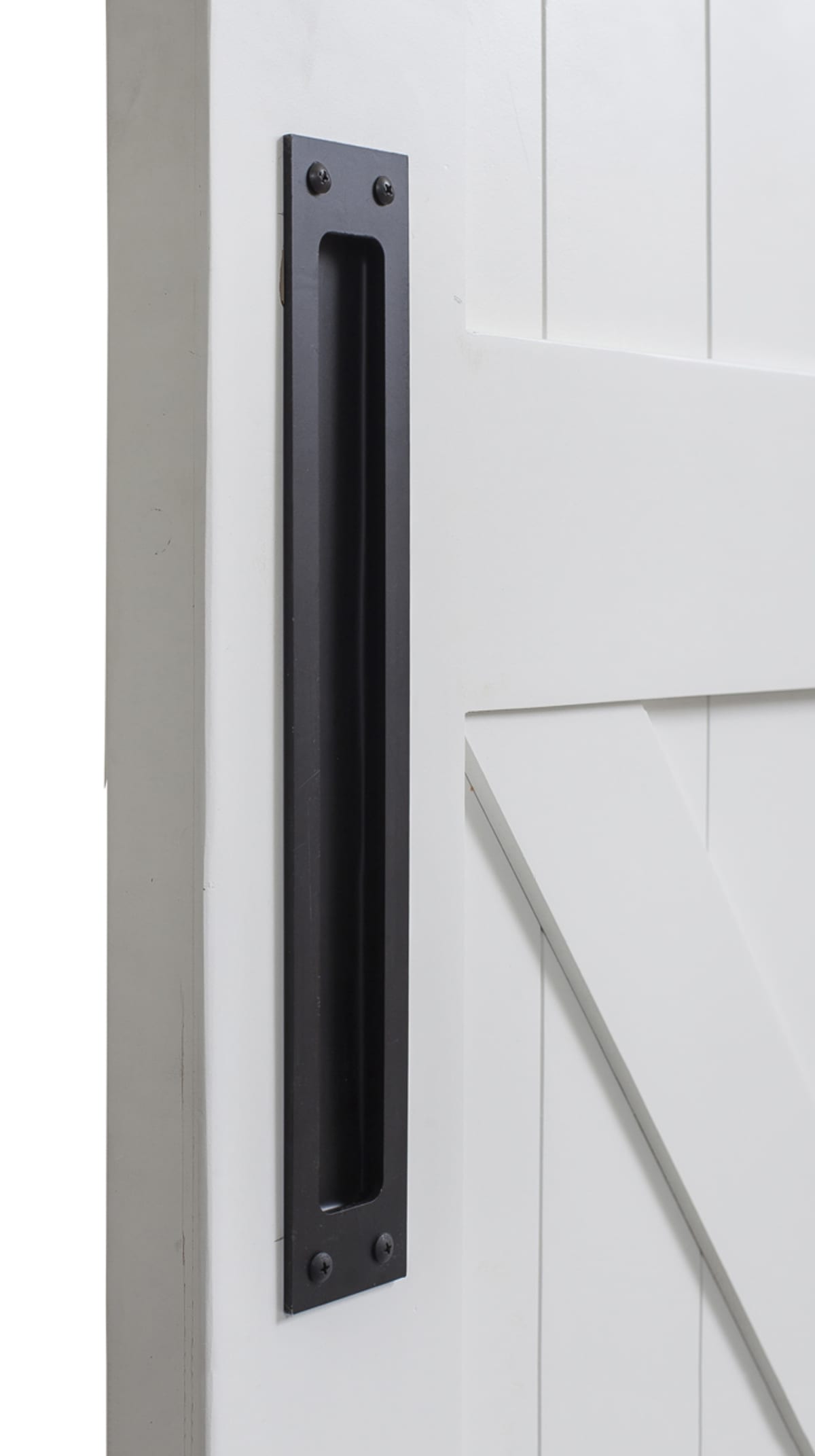 Black rectangular flush pull recessed into a white paneled door