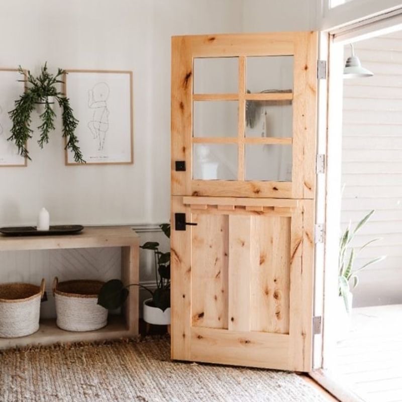 Rustica wood and glass door welcoming light into a finished home