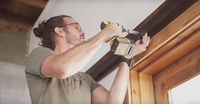 Paul Allen of Rustica hanging a barn door