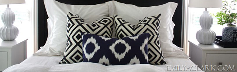 blue pattern pillows on a white bed