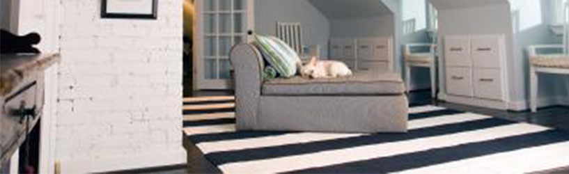 black and white striped rug in bedroom