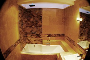 Bathroom with tiled backsplash, tub and sink