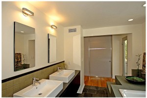 His and her bathroom sinks with lighting over mirrors