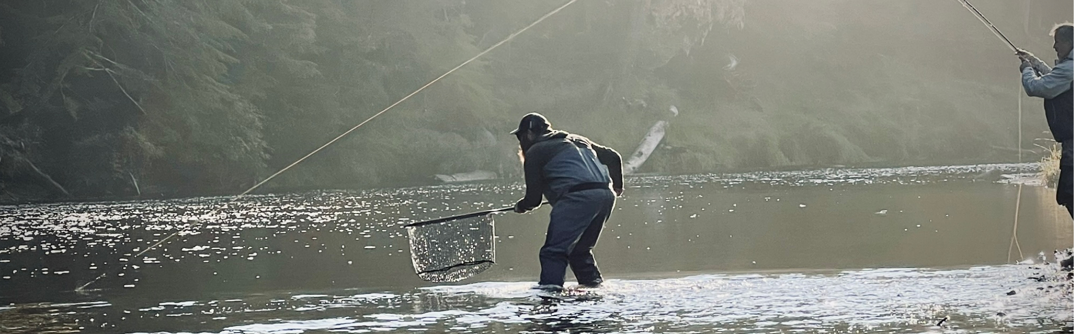 Person fishing in a misty river