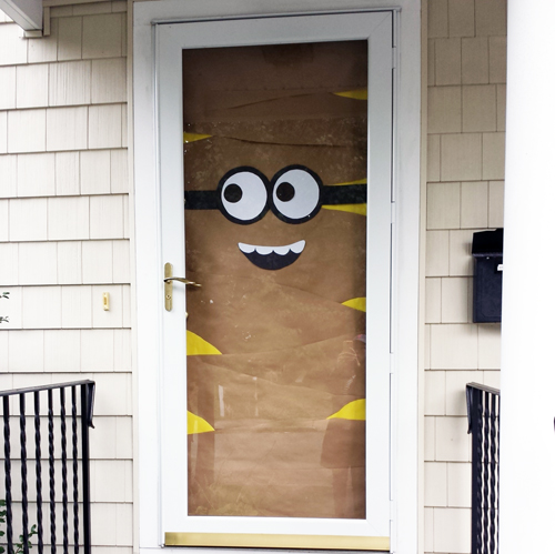 Mummy Minion door wrapped in brown paper with yellow patches and large round goggles