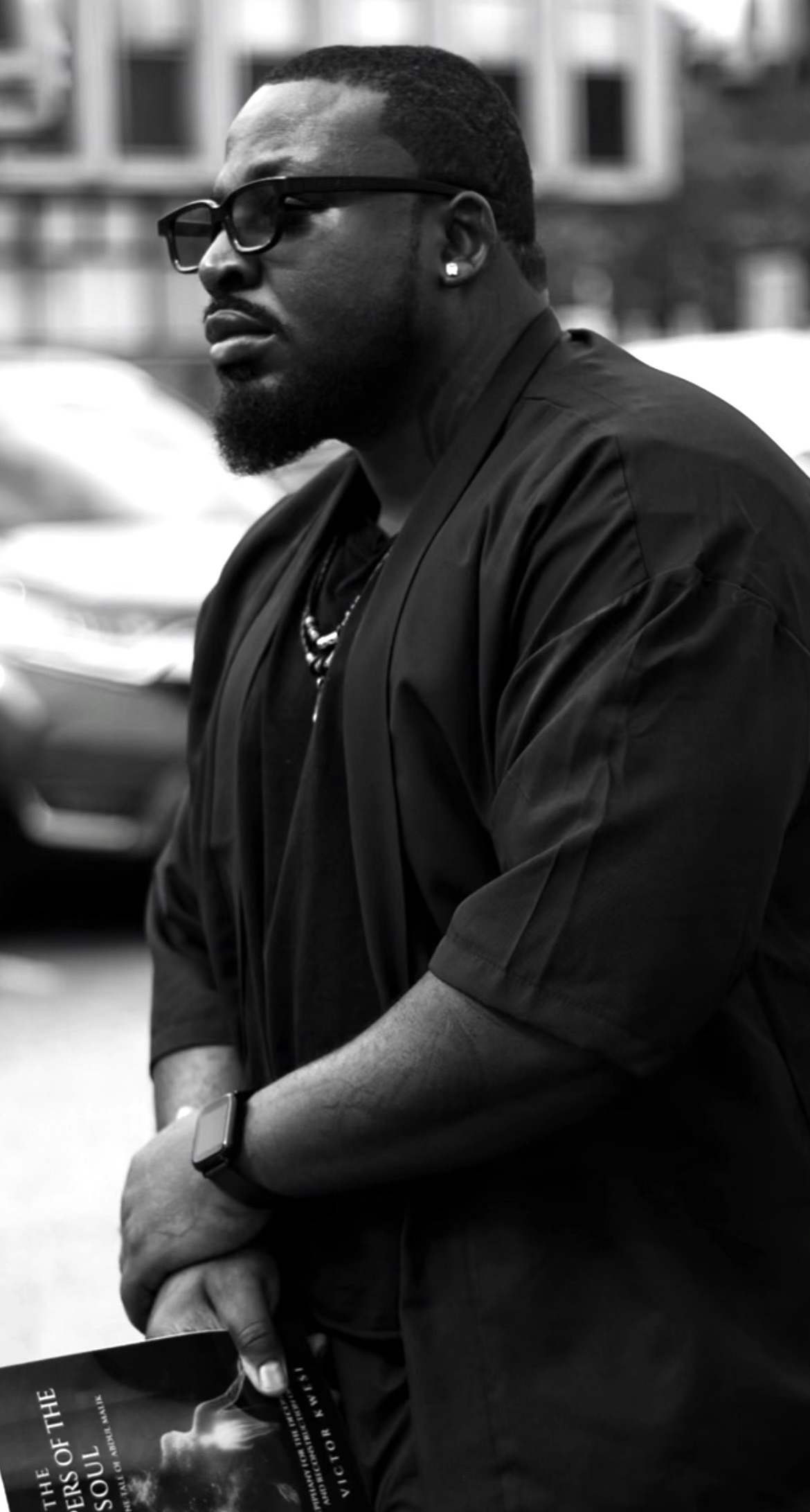 Victor Kwesi holding The Whispers of the Soul