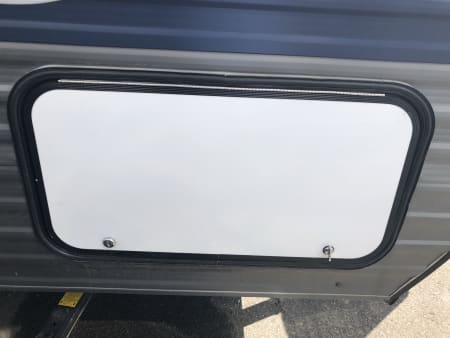 RV top hinge outside storage compartment door