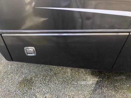 Side hinge outside storage compartment door