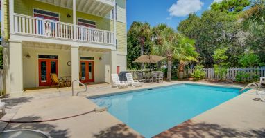 Private pool features multiple seating options, including an umbrella table 