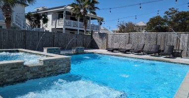 Huge pool &amp; spa with sun shelf, deck jets, waterfalls and lounge chairs