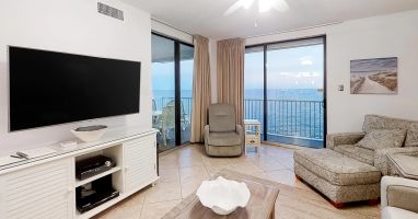 Living room with view of beach and water
