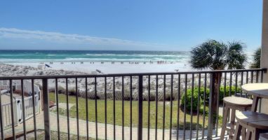 Spectacular view of the gulf and pool from balcony with lounge and dining set