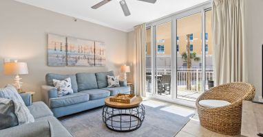 Bright and welcoming living area featuring a Smart TV with cable, comfy sleeper sofa, and easy access to the balcony.