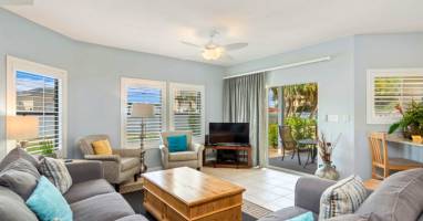 Sink into plush seating and unwind in your bright, airy living space with garden views and tropical breezes flowing through.