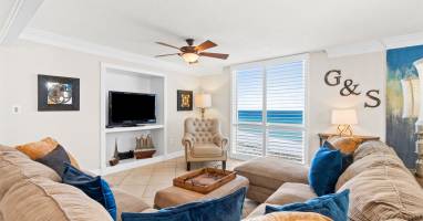 Unwind in your elegant living room where plush sectional seating and ocean views create the perfect retreat for relaxation.