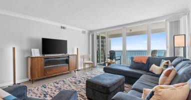 Unwind in your elegant living room with stunning ocean views through floor-to-ceiling windows. Sink into the plush sectional and enjoy your perfect coastal retreat.