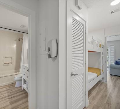The functionality of the flow of the condo is perfect for evyone to have their own space.  This shows the ensuite master bath with another access off the hall, the bunk beds and living room - separated by a pocket door.  
