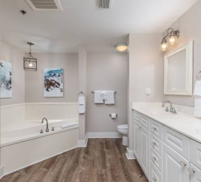 Attached bathroom with oversized tub and double sinks. Lots of storage!