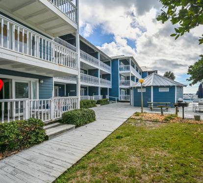 Large patio with one step for easy accessibility. View of cabana and peak-a-poo view of the Gulf and the pool with lush greenery for privacy. Beach access is just steps away from the featured cabana. 