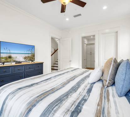 Master first floor bedroom with king bed and smart TV.