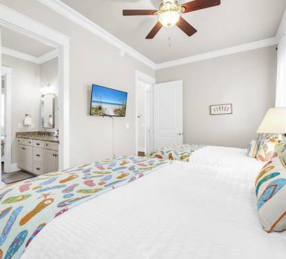 Second floor 2 queen beds with closet space and smart TV.
