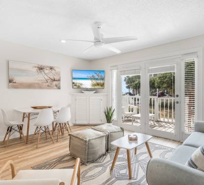 Large living room with ample seating, and a table to enjoy a home-away-from-home meal together. 