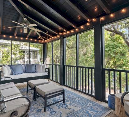 Screened Porch
A guest favorite, the screened-in porch features a cozy bed swing, sofa, rocker, and footstools. Two ceiling fans and string lights create the perfect setting for morning coffee, family time, or evening wine with peaceful wooded views.