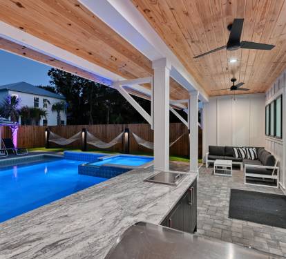 Extended covered patio with large L Shaped lounge and Summer Kitchen with grill, 50" Smart TV
