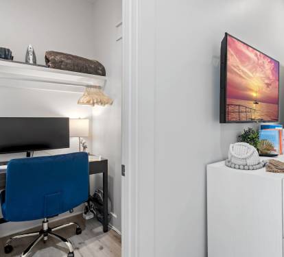 Dedicated Workspace - Tucked off the first-floor king suite, this private workspace features a small window, door, desk, comfortable chair, large monitor, docking station, keyboard, and a mouse—ideal for remote work while enjoying your beach getaway.
