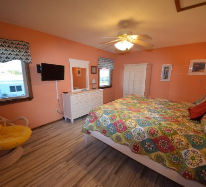 Master bedroom with king bed and attached bathroom