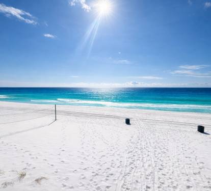 Beautiful white sandy beach with easy access from pool area.