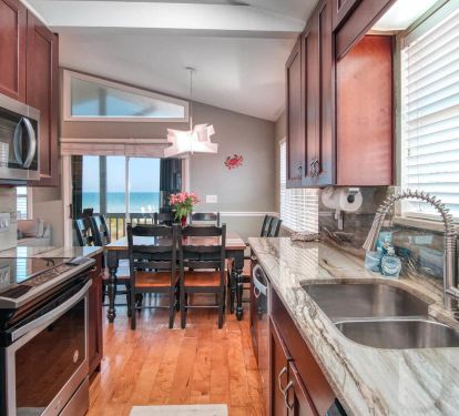 Spacious fully-equipped-granite-top kitchen and dining room overlooking beach