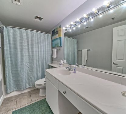 Stylish master bath with shower/tub combo. Huge vanity.