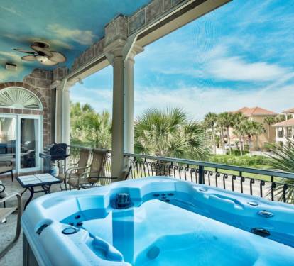 Private balcony featuring a BBQ grill, lounge area, and hot tub (propane included)