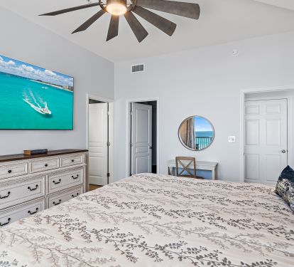 Master bedroom alternate view with dresser and TV